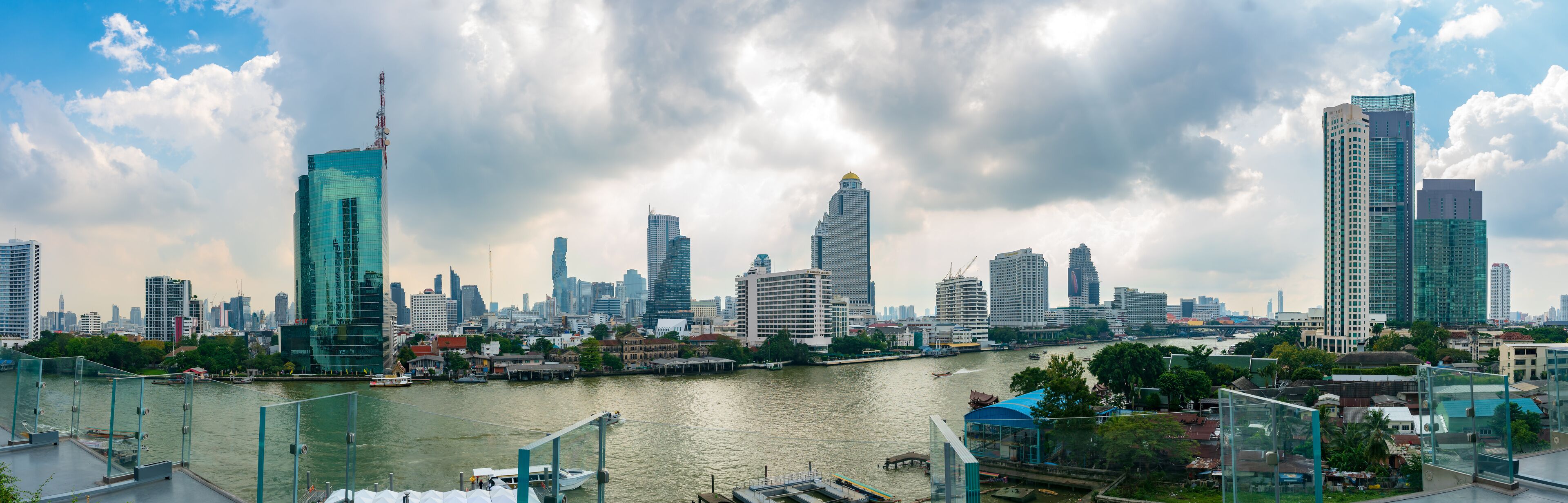 Bangkok, Thailand - November 17: Panorama view of Bangkok cityscape with Chao Phraya river on a cloudy day, seen from Iconsiam Building.