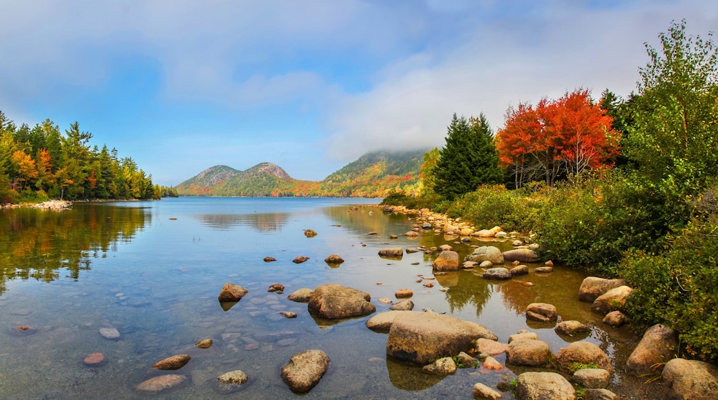 View of the clear water, stones and fall foliage of Jordan Pond in Acadia National Park
