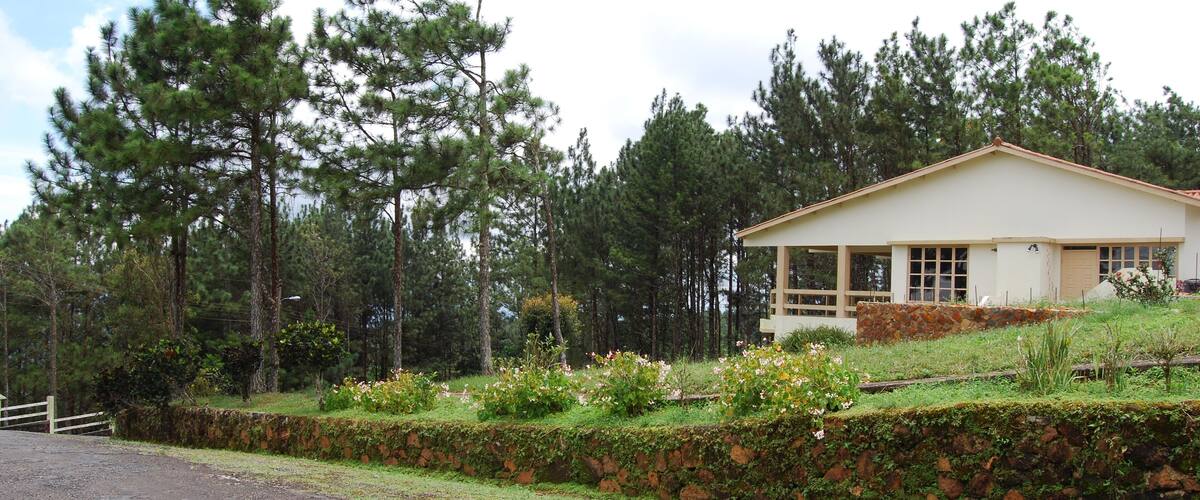 driveway in the mountain with house on one side