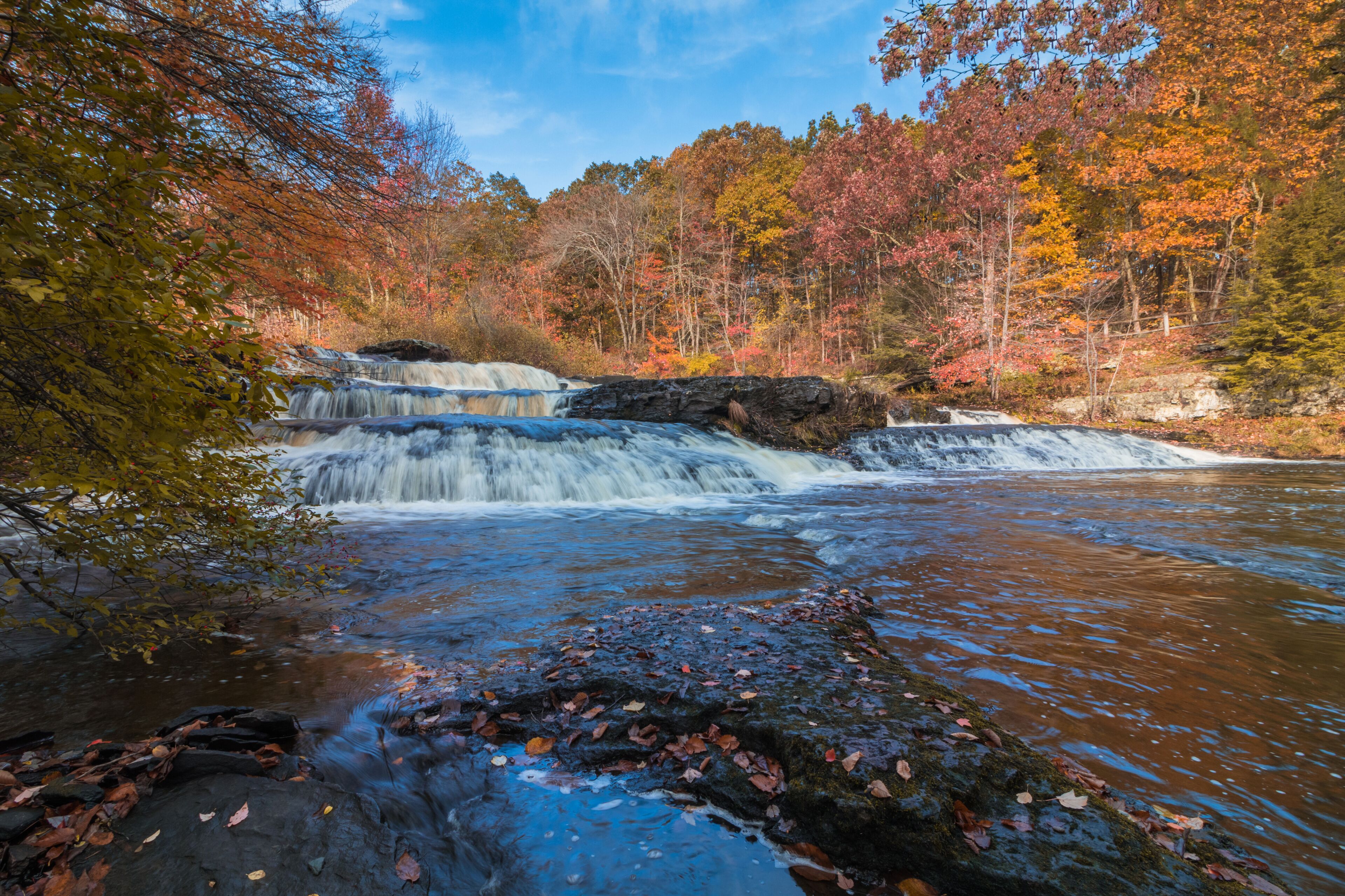 Shohola Falls in the Pennsylvania Poconos on a beautiful fall morning surrounded by peak fall foliage.  Waterfalls in the fall.