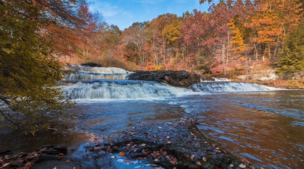 Shohola Falls in the Pennsylvania Poconos on a beautiful fall morning surrounded by peak fall foliage. Waterfalls in the fall.