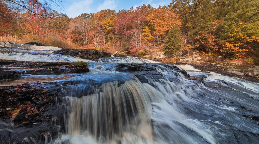 Shohola Falls in the Pennsylvania Poconos on a beautiful fall morning surrounded by peak fall foliage. Waterfalls in the fall.