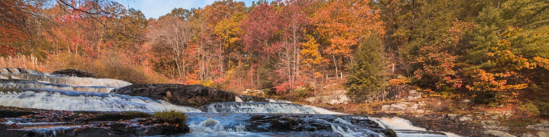 Shohola Falls in the Pennsylvania Poconos on a beautiful fall morning surrounded by peak fall foliage. Waterfalls in the fall.
