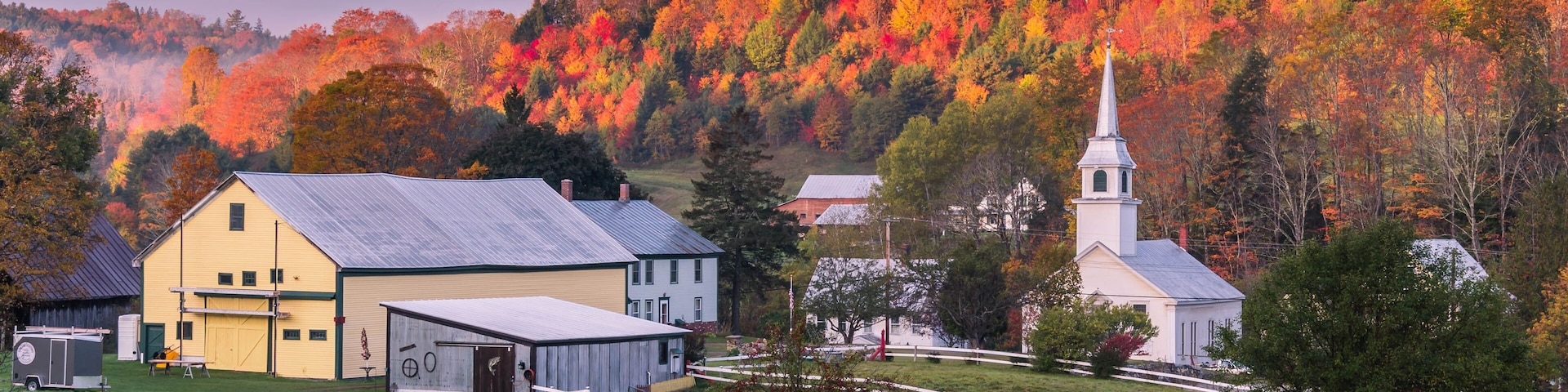 Beautiful view of the buildings and autumn trees in the east Corinth Vermont village at sunset