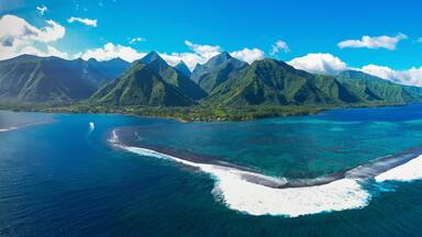 Aerial view of turquoise waters and coral reef in sunset, Passe Havae, Tahiti, French Polynesia.