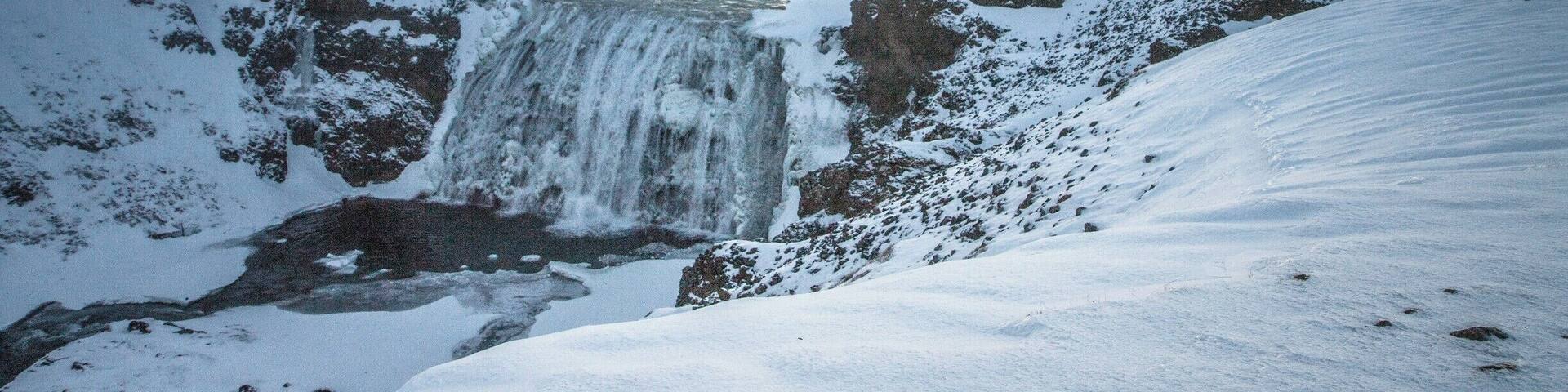 Well worth the short detour off the Golden Circle to þórufoss waterfall... The dawn sky makes it even more beautiful, and the bonus is that, at Christmas time dawn is 11:30am :-)