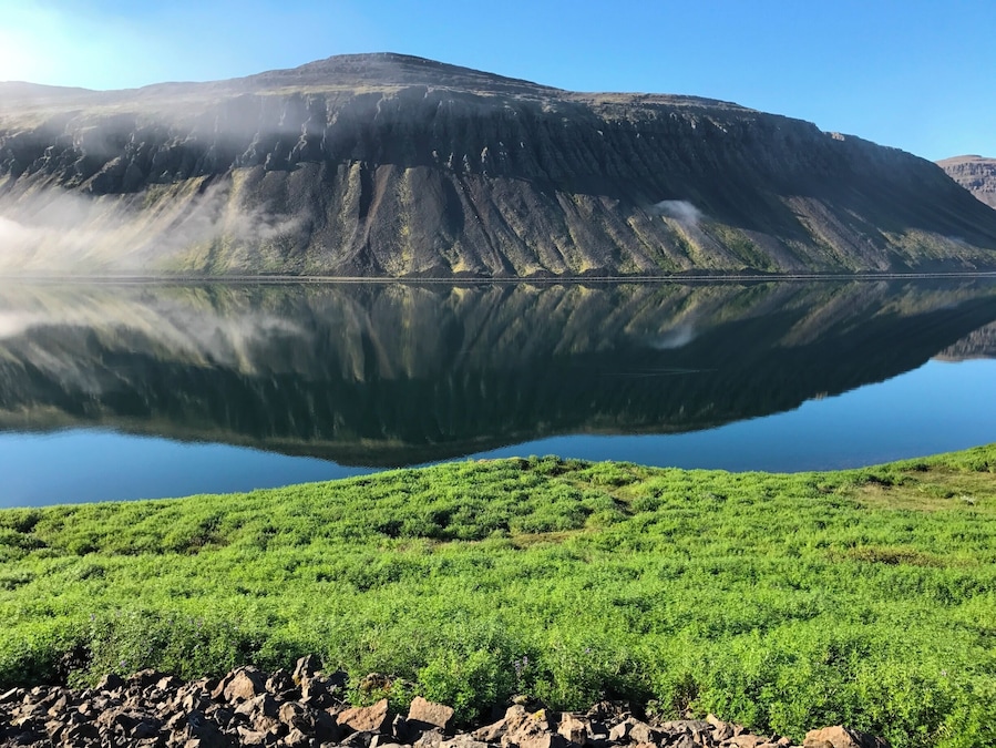 The Westfjords of Iceland is a large peninsula in northwestern Iceland. It has a mountainous coastline, heavily indented by dozens of fjords surrounded by steep hills. These fjords make roads circuitous and difficult to drive. The mountain scenery is rugged but specular.