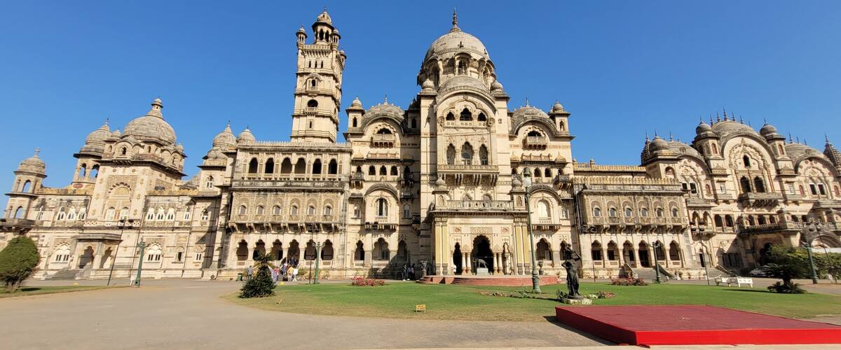 A large, ornate building with multiple domes and a tall tower.