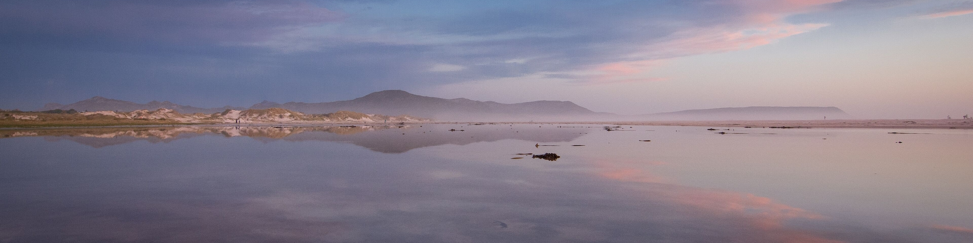Pink and blue skies of winter above the lagoon on Noordhoek Beach, Cape Town, South Africa