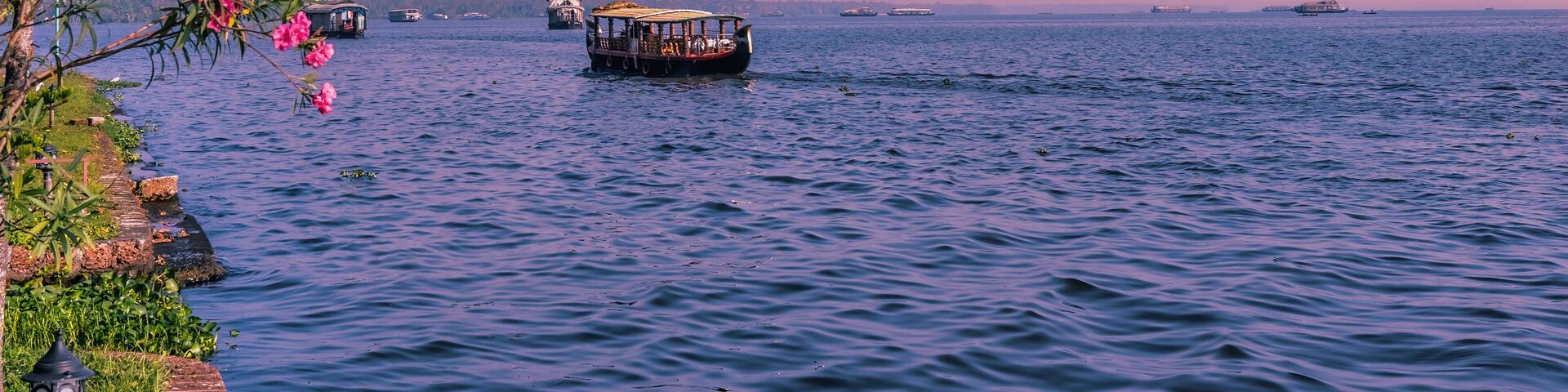 Beautiful landscape with a house boating in marine drive, Kochi, India. Travel and tourism Kerala - houseboat on Alleppey backwaters in India. Kerala houseboat image. High quality photo