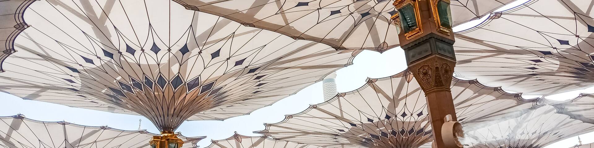 MEDINA, SAUDI ARABIA - APRIL 28 2018: These Umbrella construction on the square of Al-Masjid An-Nabawi or Prophet Muhammed