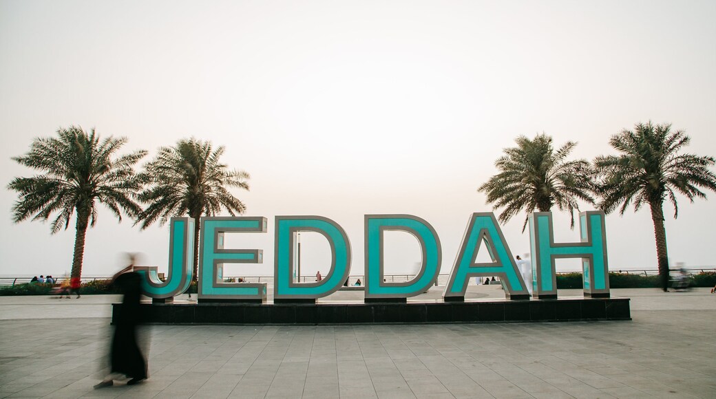 Corniche featuring outdoor art and signage