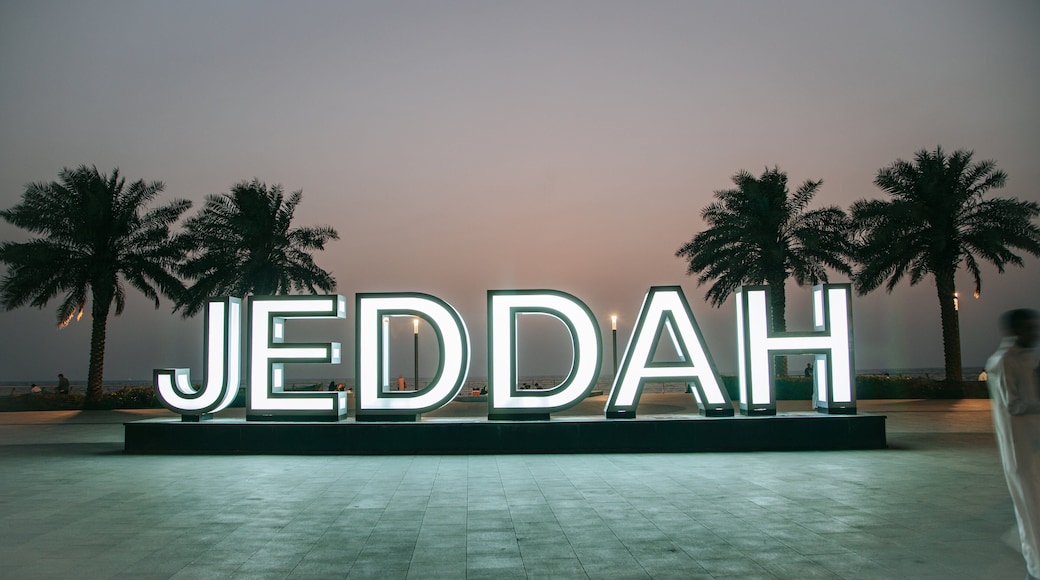 Corniche featuring signage and night scenes