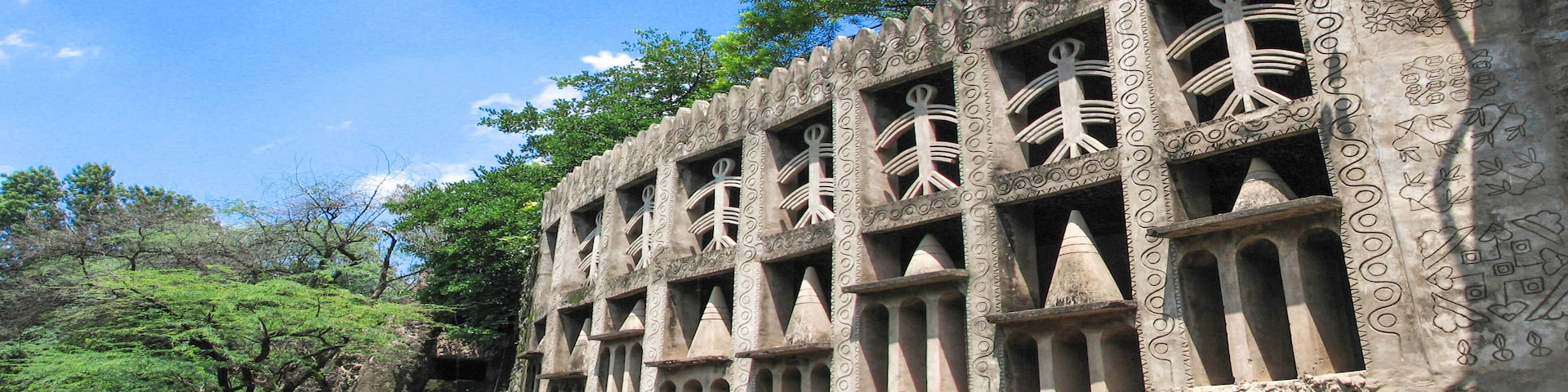 A stone building with intricate carvings and multiple arched windows.