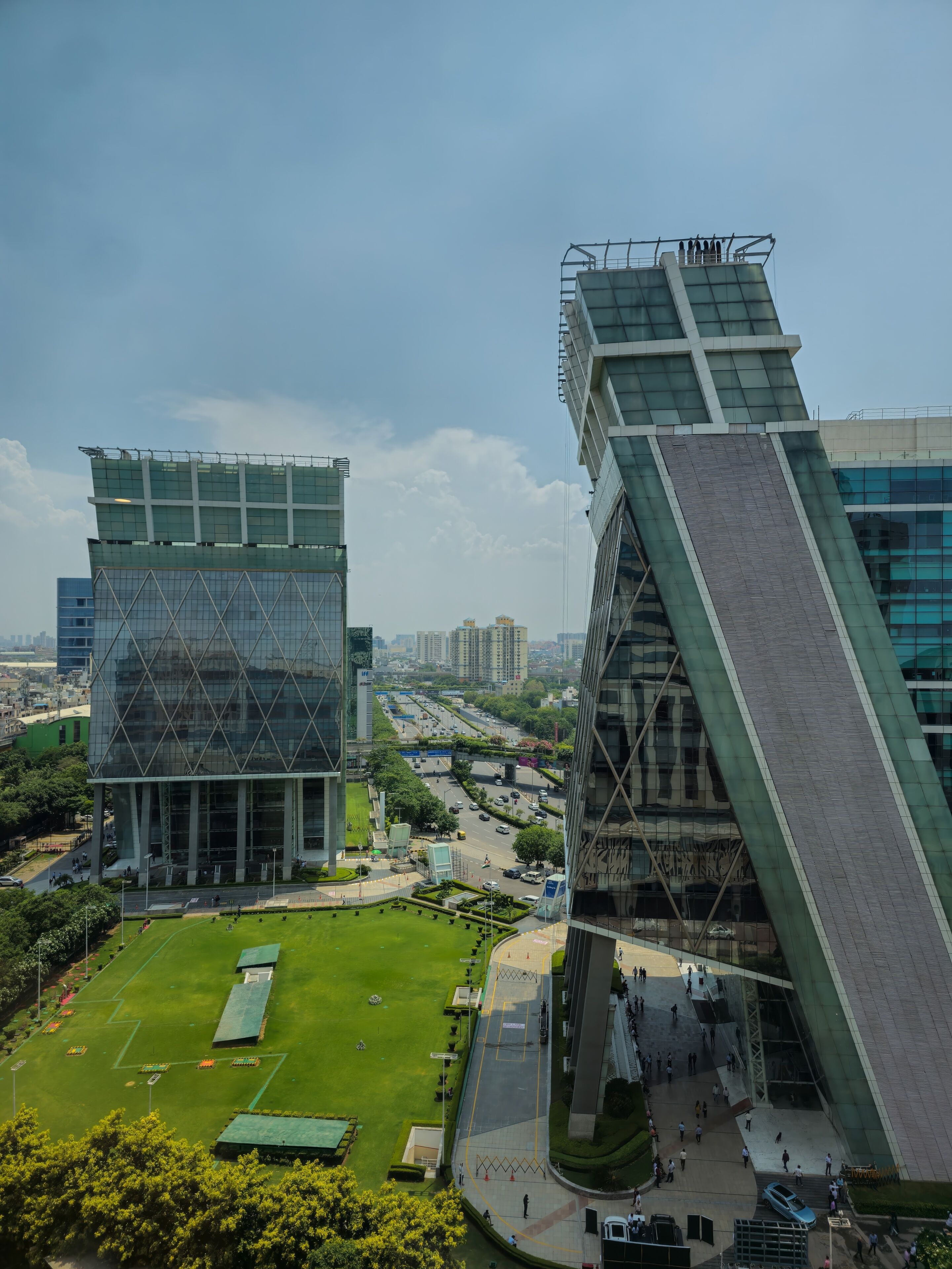 Gurgaon (Gurugram) National Capital Region (NCR), Haryana, India -  June 6, 2023 : Unique view of Cyberhub buildings from upper floors in Cyber City with lawn and traffic road