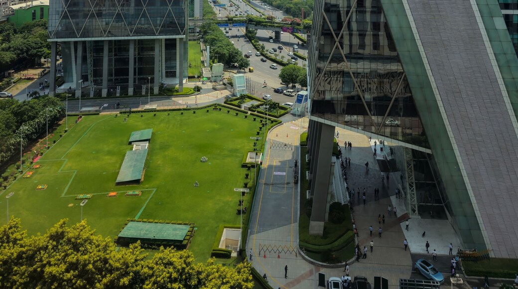 Gurgaon (Gurugram) National Capital Region (NCR), Haryana, India - June 6, 2023 : Unique view of Cyberhub buildings from upper floors in Cyber City with lawn and traffic road
