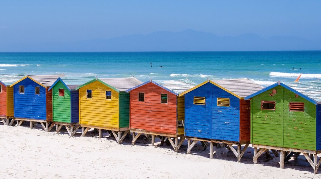 Colorful beach huts line the shores of Muizenberg beach in Cape Town, South Africa