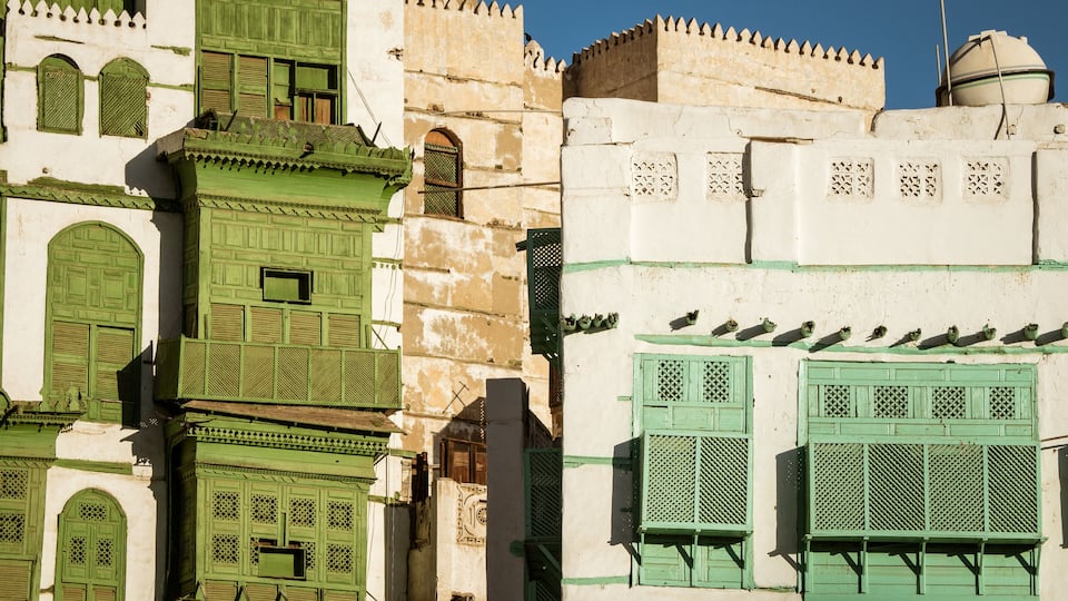 View of the famous greenish Noorwali coral town house at the Souk al Alawi Street in the historic city center of Al Balad, Jeddah, Saudi Arabia