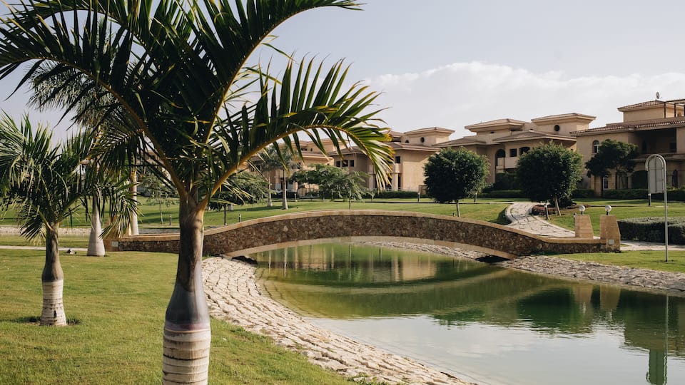New Cairo, Egypt - 11.21.2021: Beautiful lake and bridge at villas area at Madinaty compound, luxury living in Egypt