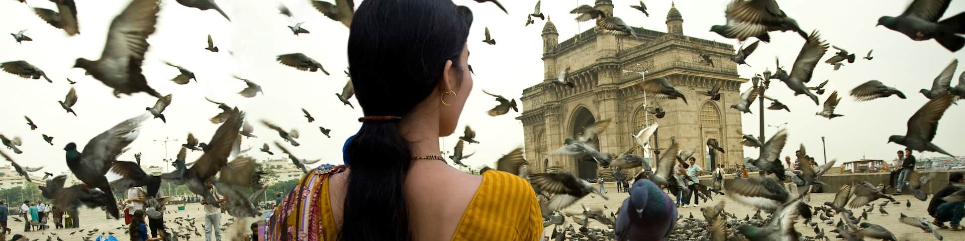 Panoramic view of gateway of india mumbai wome holding pigeon in hand maharashtra India Asia, South Asia.. ..