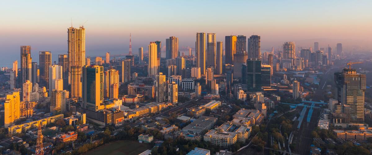Mumbai skyline lit up in gold by the sunrise.