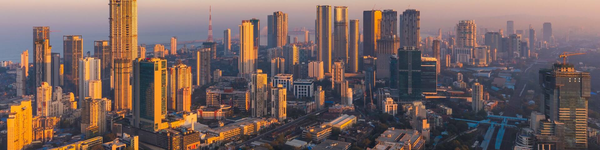 Mumbai skyline lit up in gold by the sunrise.
