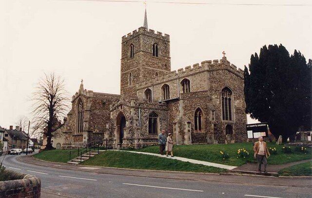 A historic stone church with a prominent tower and arched windows.