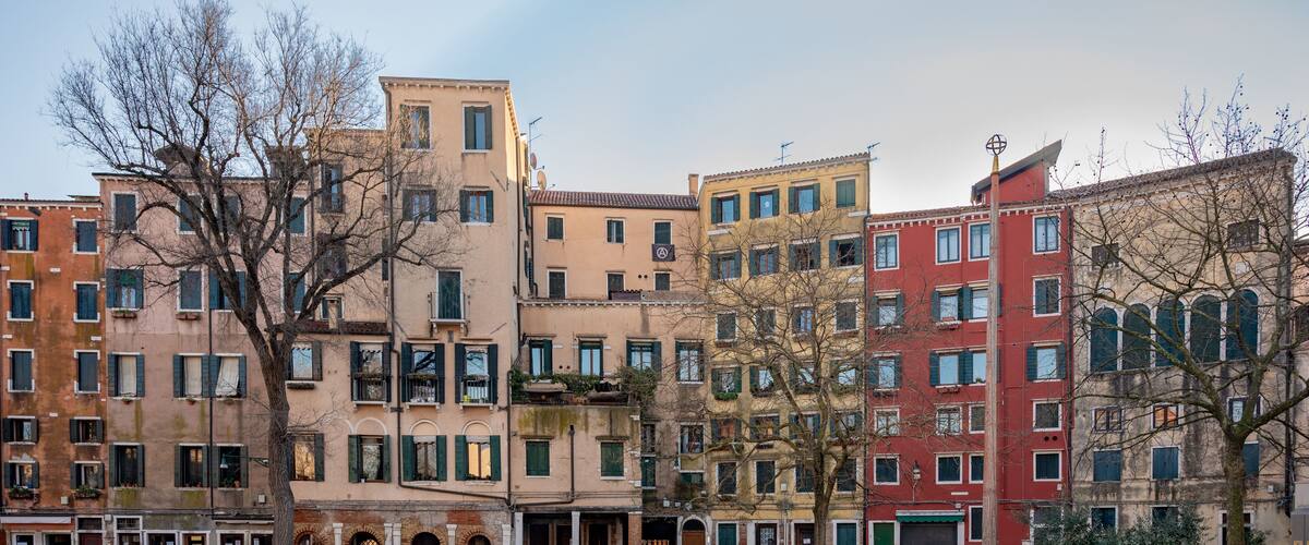 Facades of buildings on the Campo del Ghetto nuovo square in the Jewish Ghetto district. Venice, Italy.