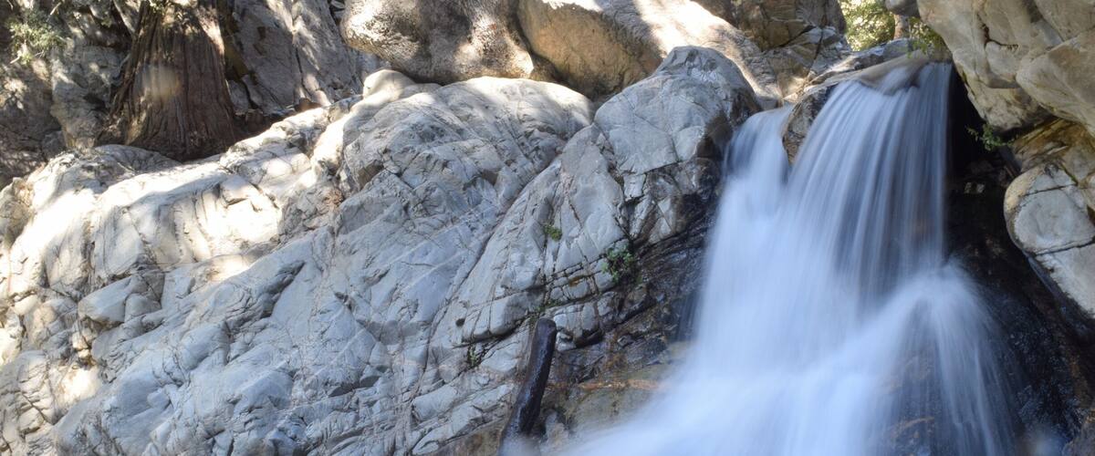 A waterfall cascading over rocks in a natural setting.