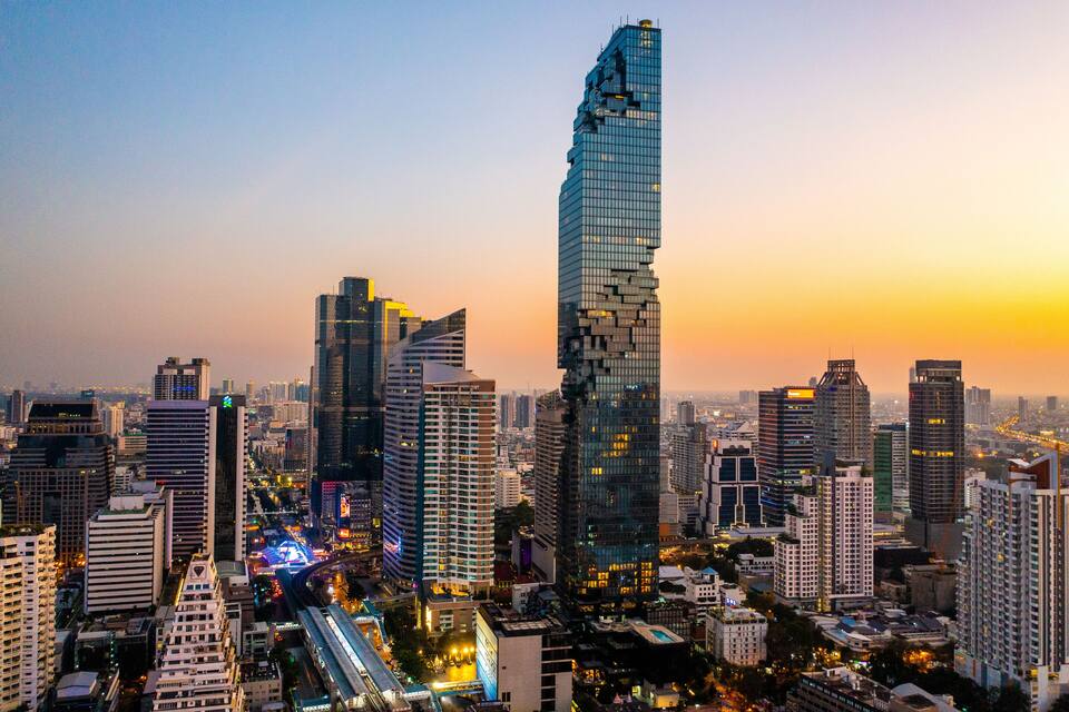A cityscape with modern skyscrapers and a sunset.