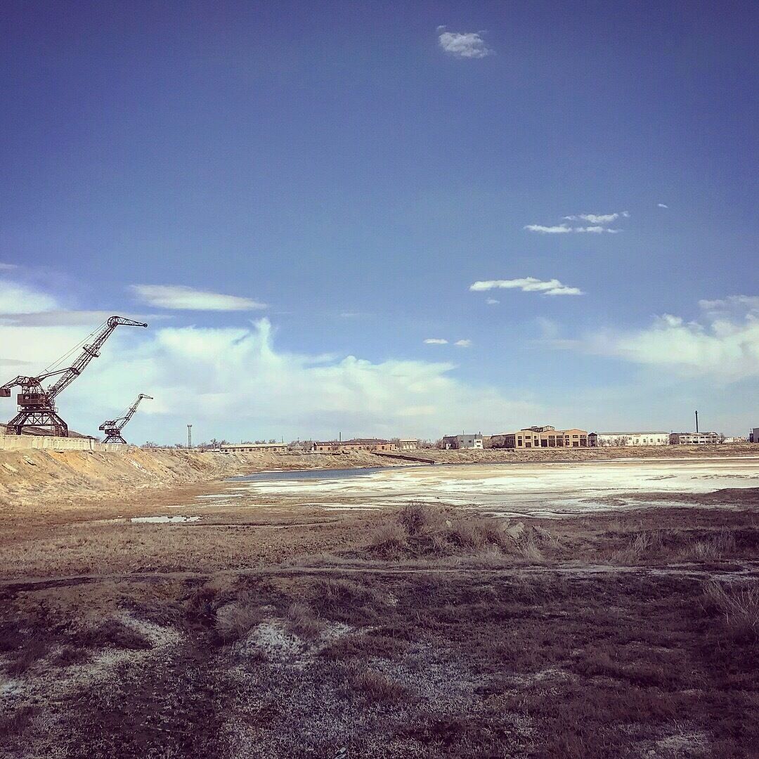 A construction site with heavy machinery and a large open area.