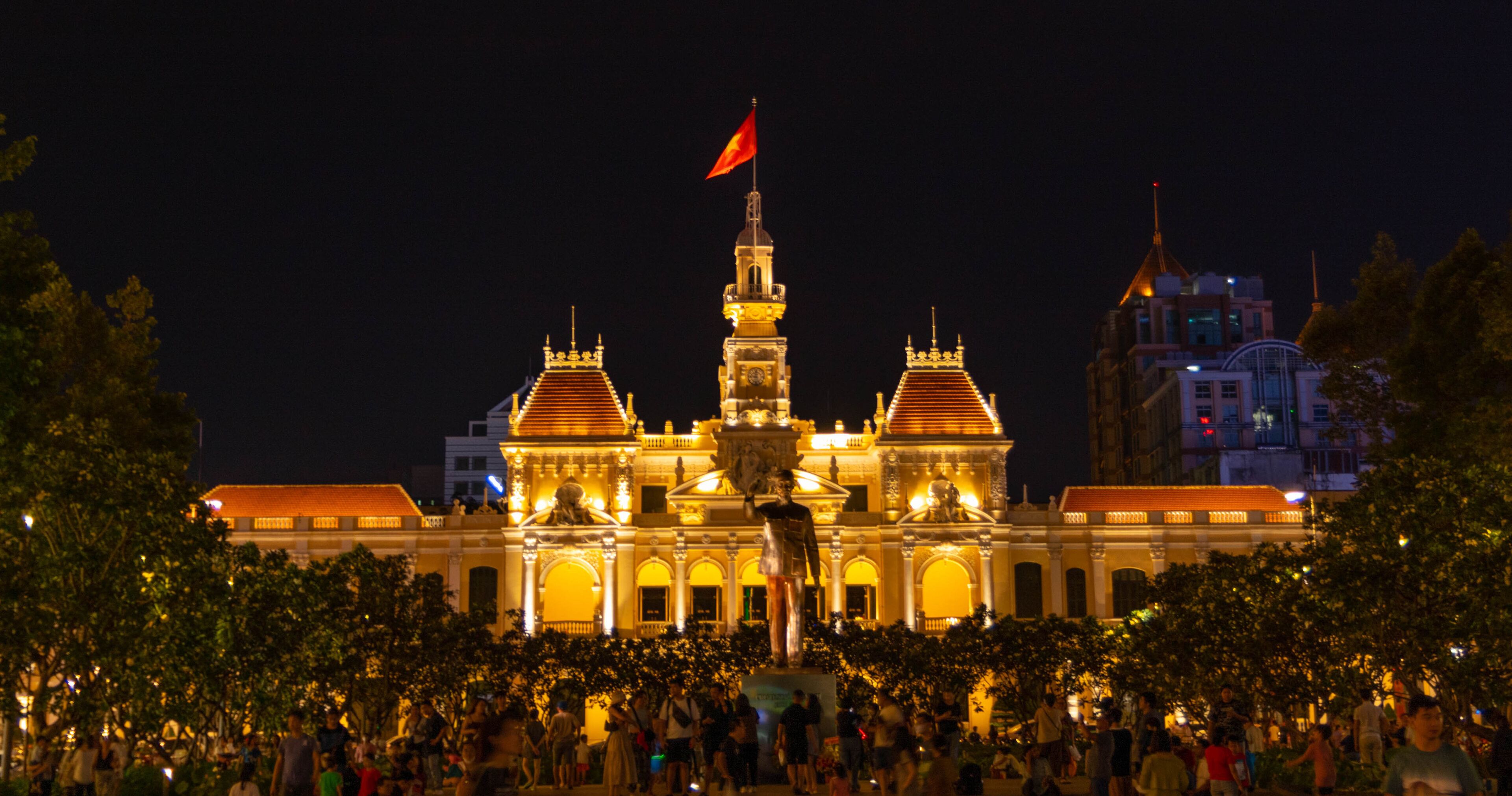Ho Chi Minh statue stands in front of the People's Committee Building on Nguyen Hue walking street  at night in District 1, Ho Chi Minh city, Vietnam.