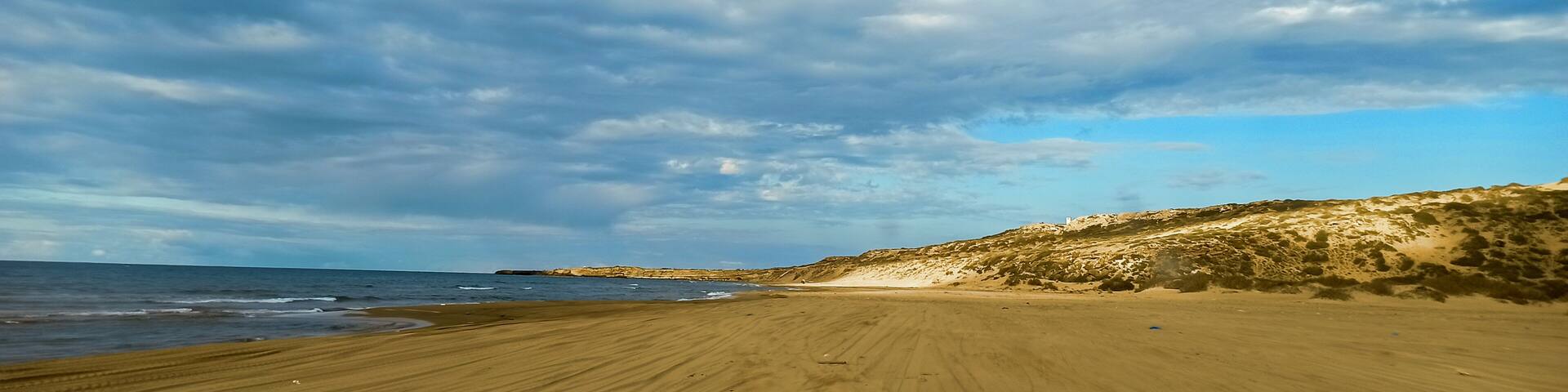 Panoramic view of beach and seaside under a cloudy sky during summertime, Tourism concept. Mostaganem, Algeria
