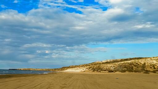 Panoramic view of beach and seaside under a cloudy sky during summertime, Tourism concept. Mostaganem, Algeria
