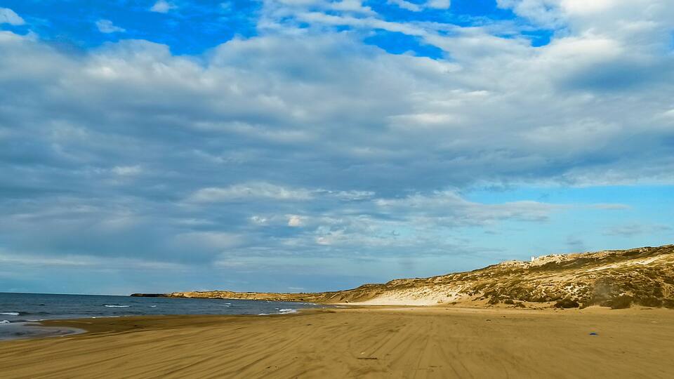 Panoramic view of beach and seaside under a cloudy sky during summertime, Tourism concept. Mostaganem, Algeria