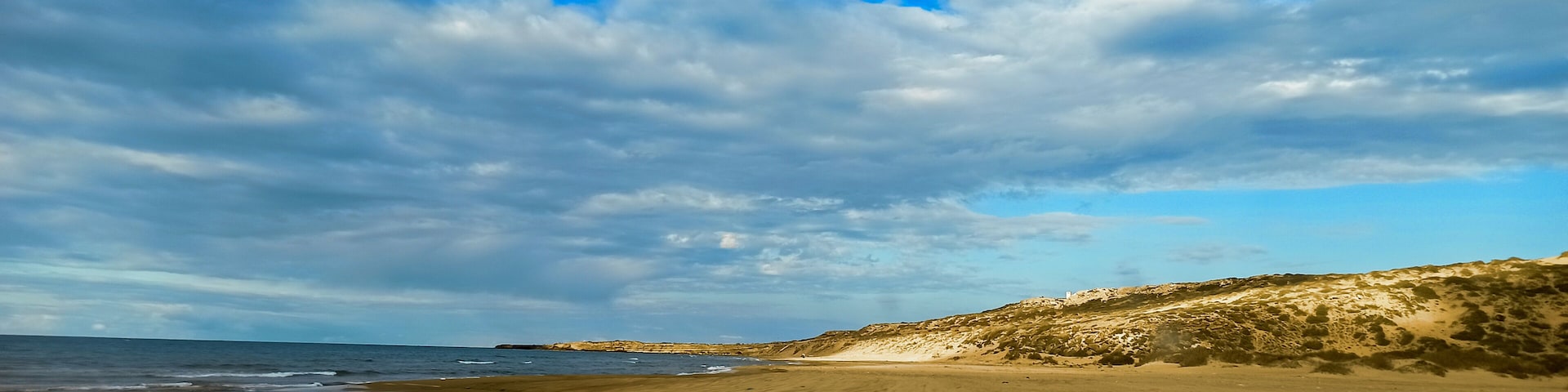 Panoramic view of beach and seaside under a cloudy sky during summertime, Tourism concept. Mostaganem, Algeria