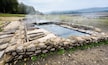 Natural Roman baths outdoors with hot steam and thermal water.