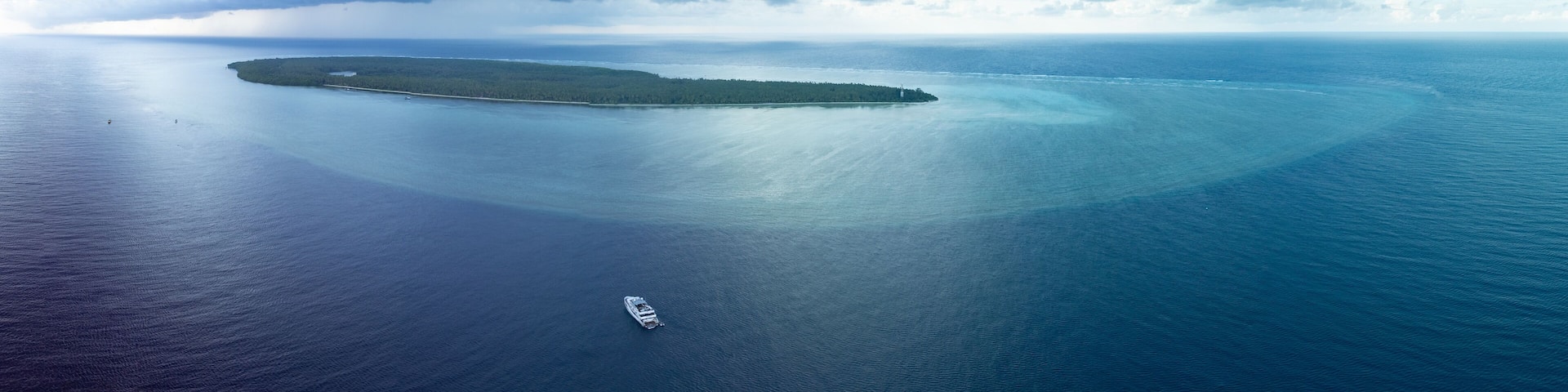 An aerial view of a large island surrounded by calm ocean waters.