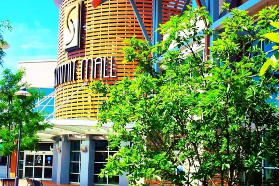 A modern building with a circular design, featuring a prominent 'S' logo and the name 'SOMERSET MAIL'.
