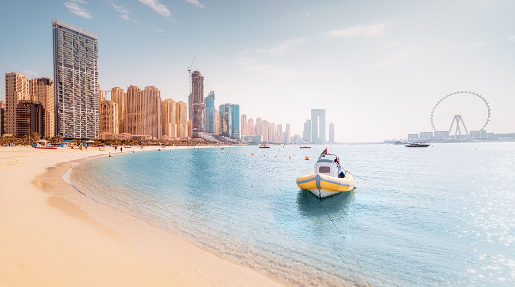 Boat moored to the pier and the largest Ferris Wheels in the World is the Dubai Eye. Top tourist attractions in the United Arab Emirates