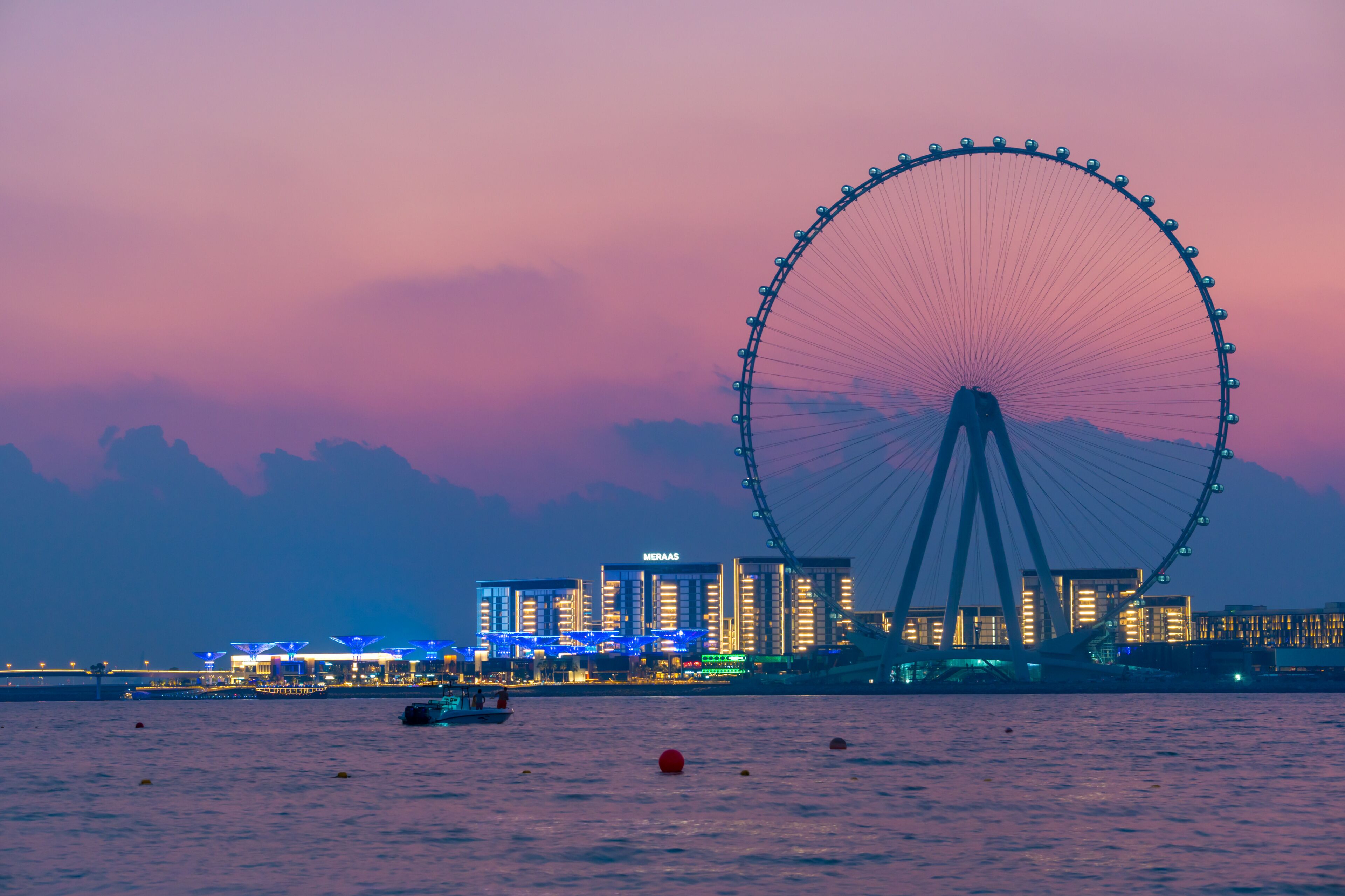 Amazing sunset colors over the sea view to the Ain Dubai, giant Ferris at artificial island Bluewaters Island  close to JBR beach. Dubai Eye fits perfect to modern UAE skyline