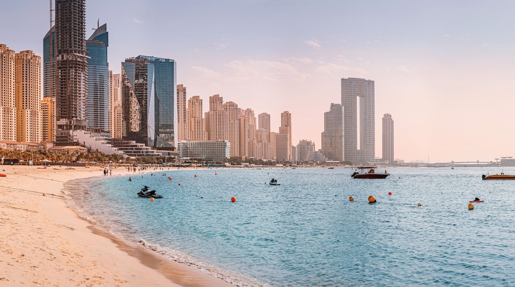 Panoramic views of the Persian Gulf beach and Bluewaters Island with the worlds famous largest Ferris wheel Dubai Eye and numerous skyscrapers with hotels and residences