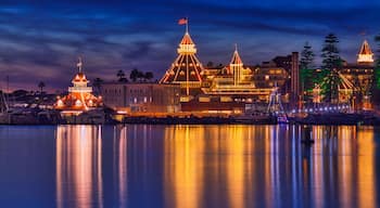 Historic hotel decorated with holiday lights during Christmas with reflections in the water