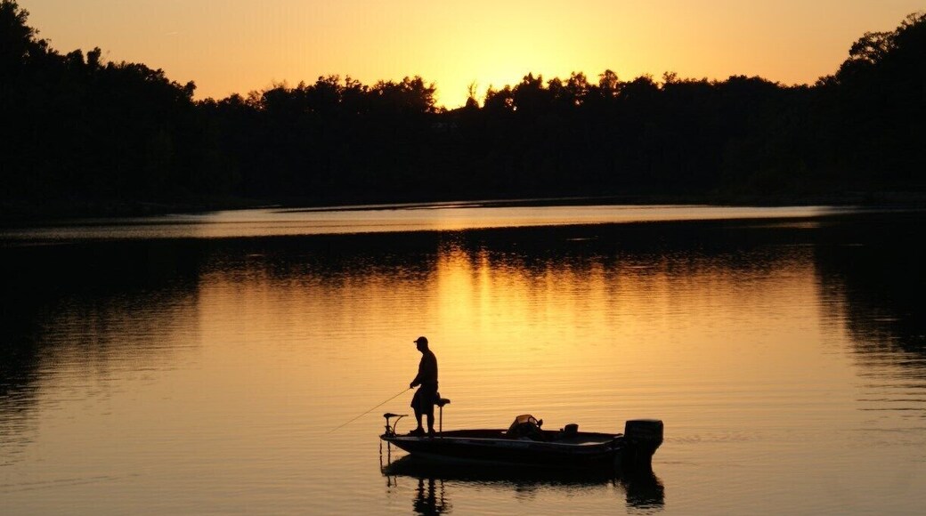 Lone fisherman at dusk on beautiful Nolin Lake.