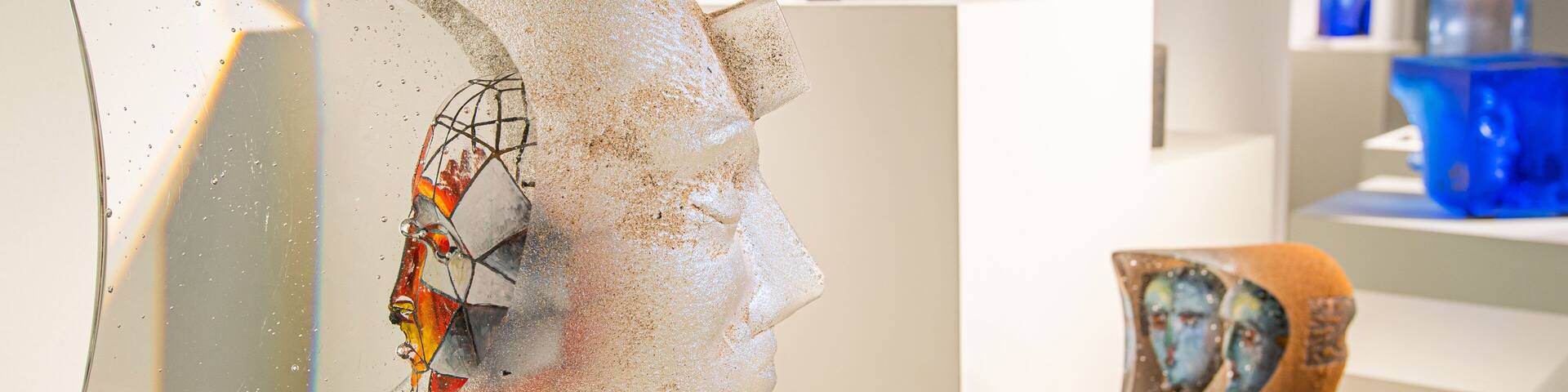 A sculpture of a human head on a pedestal.