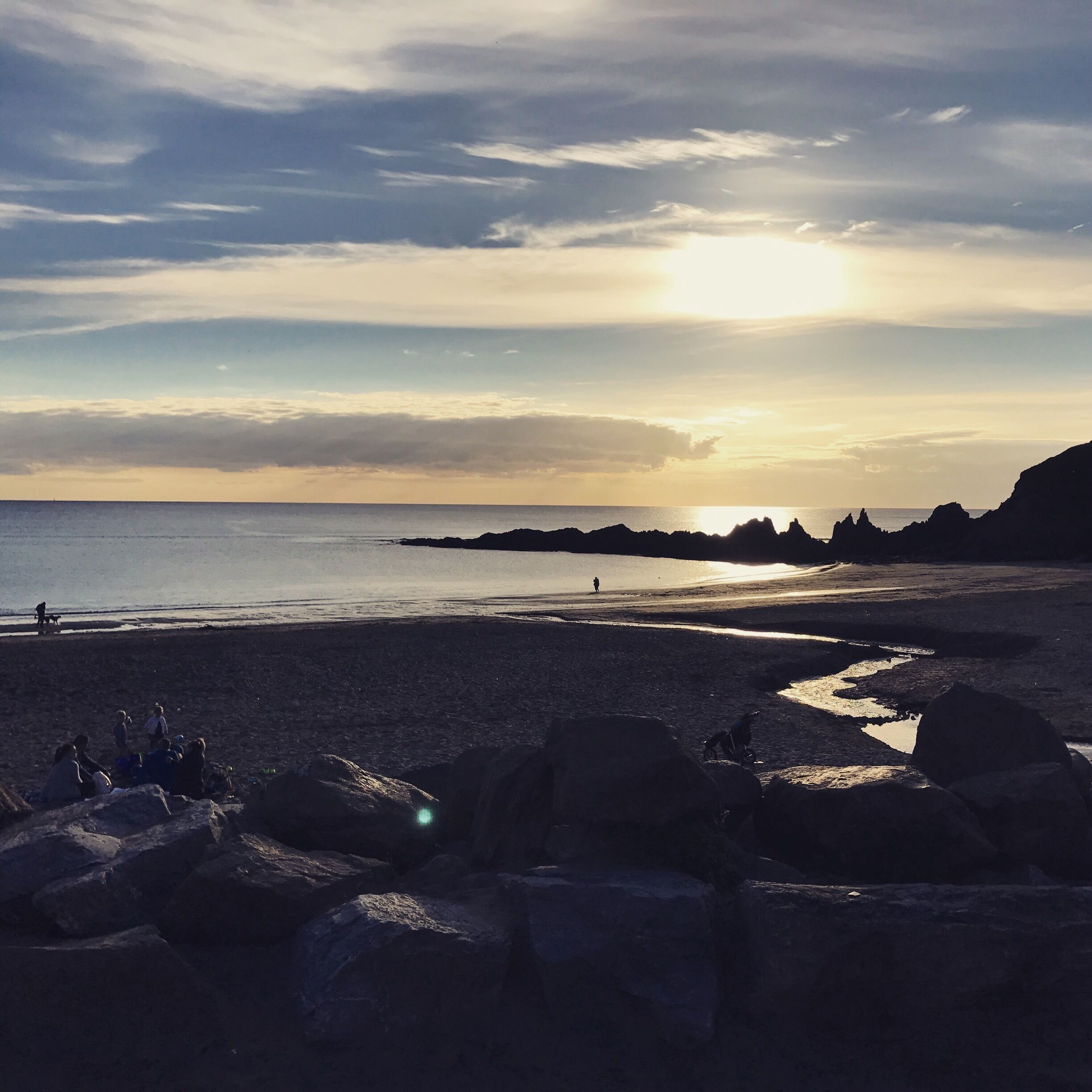 A beach with rocks and people.