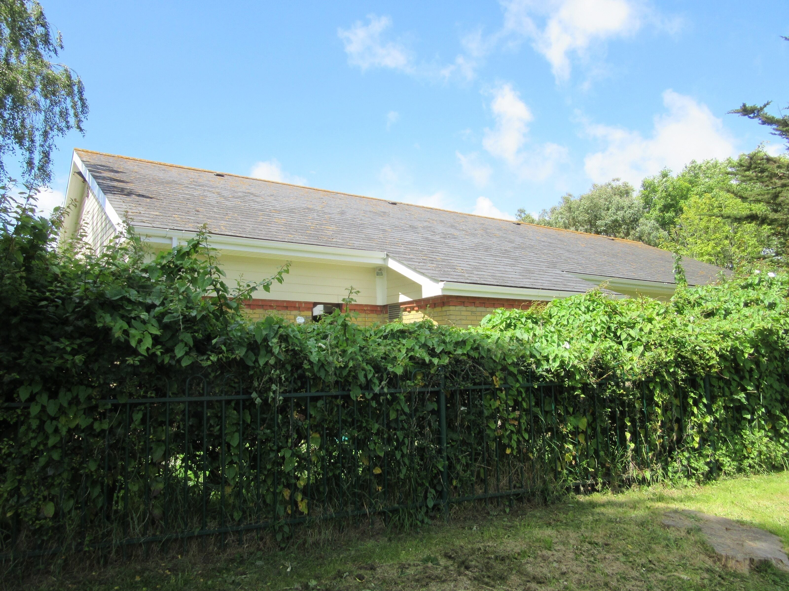 Kingdom Hall, Manor Road, Lake, Isle of Wight, England. This Kingdom Hall of Jehovah's Witnesses is next to Sandown Cemetery and is accessed off Manor Road. This photo was taken from the cemetery. The building is modern: it was registered for marriages in 1991.
