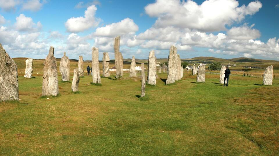 A stone circle with a person standing in the foreground.