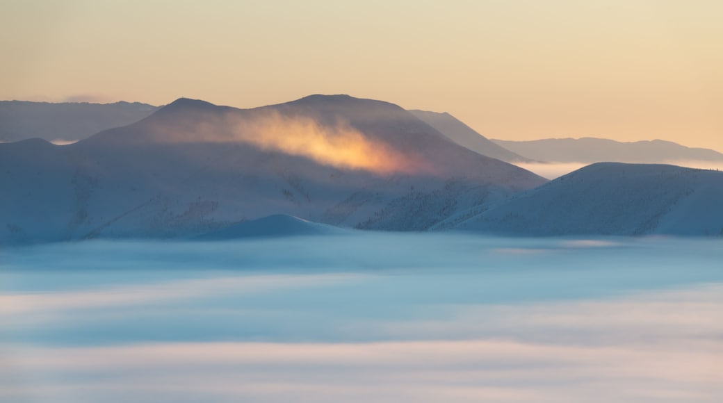 Winter landscape in foggy day at sunrise. A rainbow in mountains on Olchansky pass in Oymyakon, Sakha Republic, Russia. Top view
