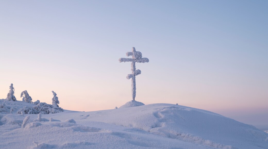Snow-covered Cross on the Olchansky Pass near the village of Ust-Nera, Oymyakon District, Sakha Republic, Russia. The cross is installed near a dangerous Kolyma highway, called the road on bones